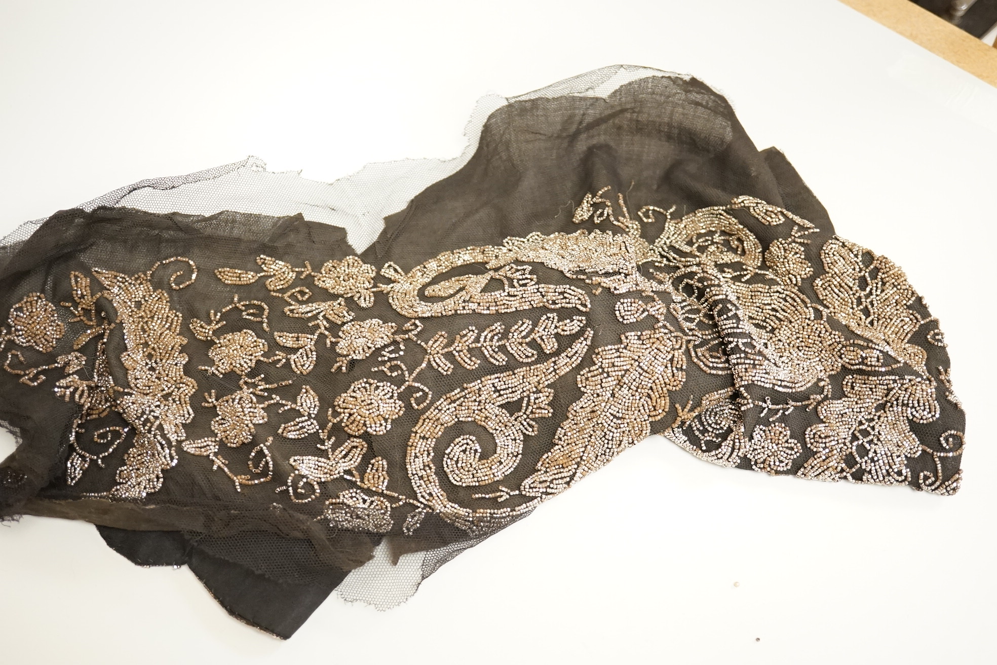 A cut steel fronter, a jet beaded panel, a pair of fringed black suede gauntlets, a seed pearl headdress, etc.
